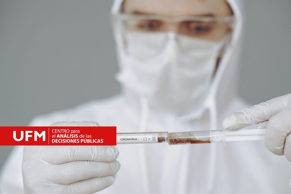 person-holding-test-tube-and-syringe-4149033